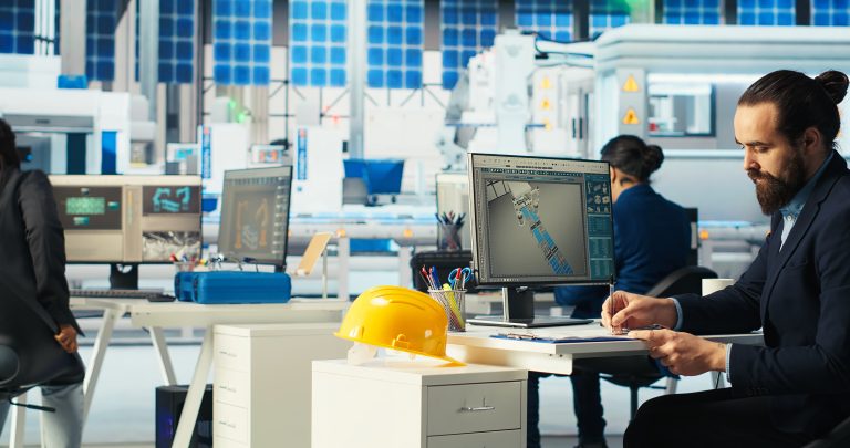 Engineer in photovoltaics factory taking notes of upgrades to make